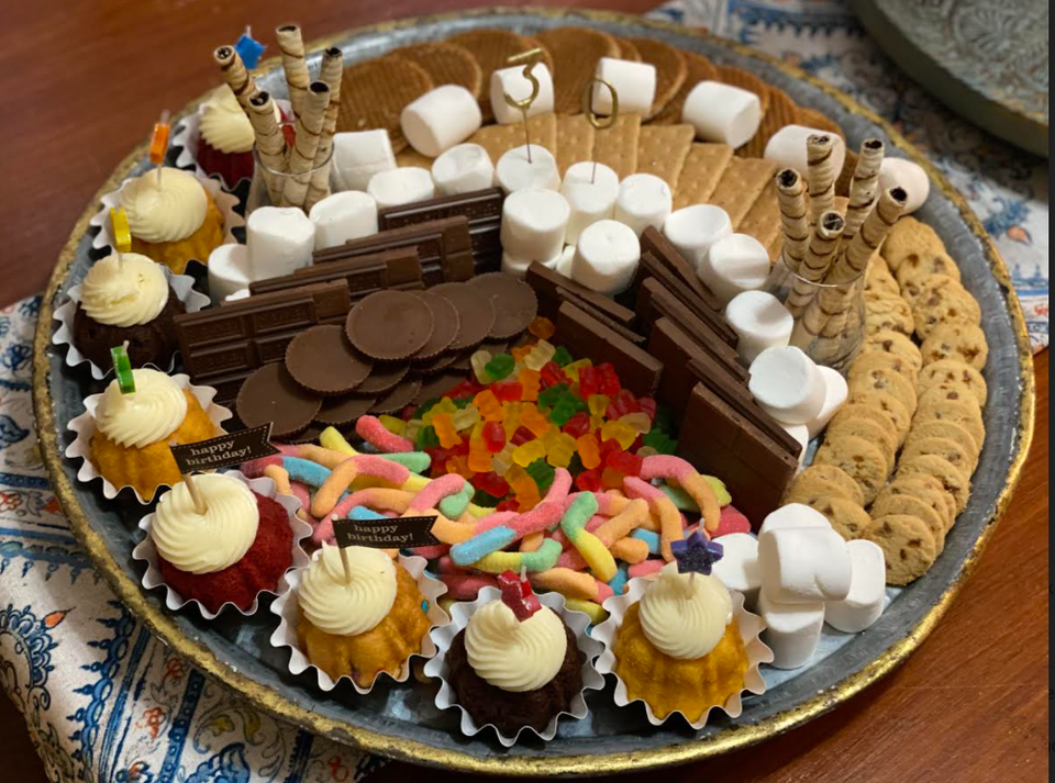 Dessert plate filled with smores making ingredients and homemade cupcakes.